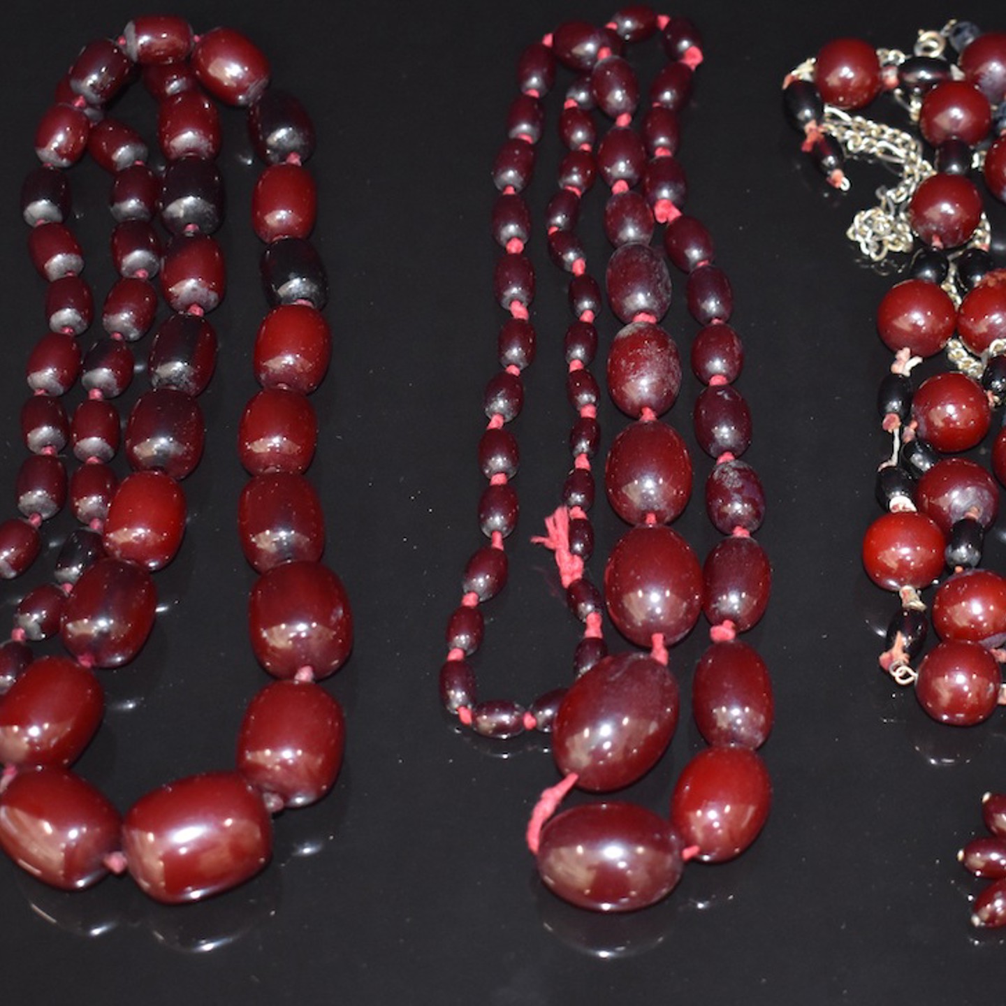 Three Cherry Amber Necklaces And A Cherry Amber Brooch. Sold For £480