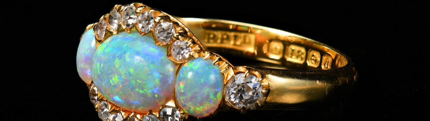 An 18Ct Gold Ring Set With Three Opals And Old Cut Diamonds. Sold For £1,100