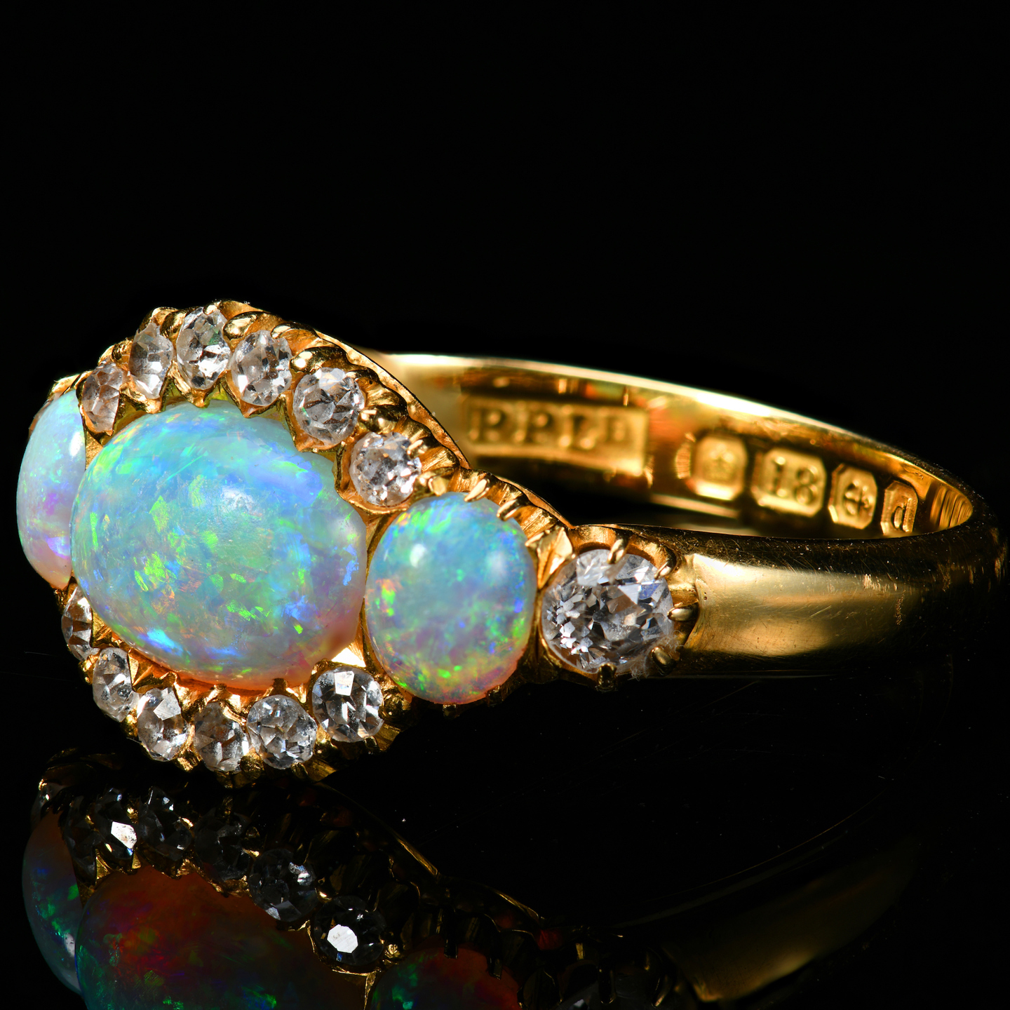 An 18Ct Gold Ring Set With Three Opals And Old Cut Diamonds. Sold For £1,100