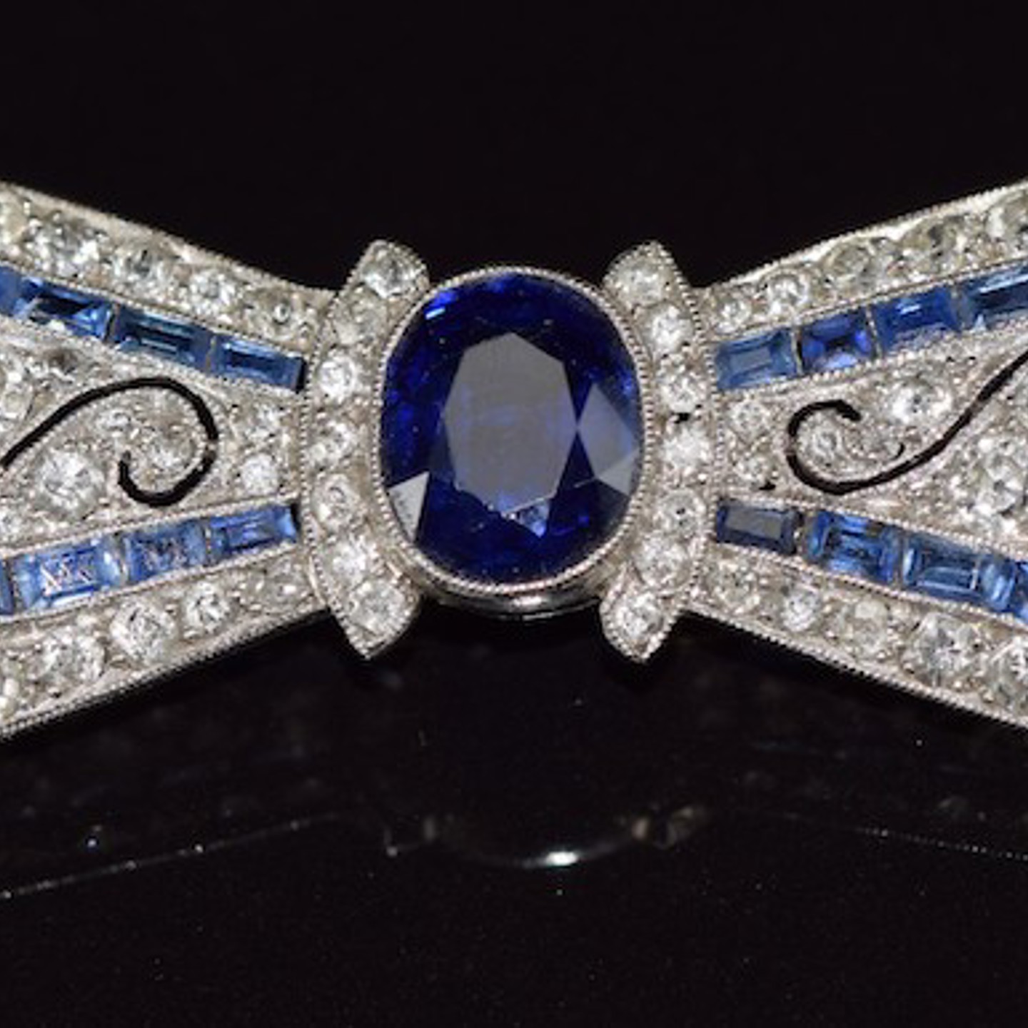 Platinum Brooch In The Form Of A Bow Set With An Oval Cut Sapphire.. Sold For £3,200