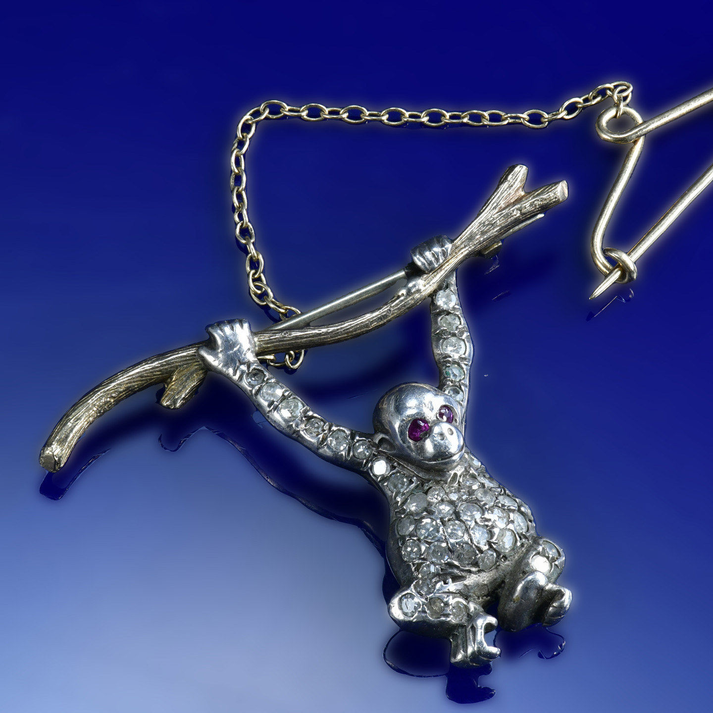 A 9ct gold and silver brooch set with diamonds and rubies in the form of a monkey