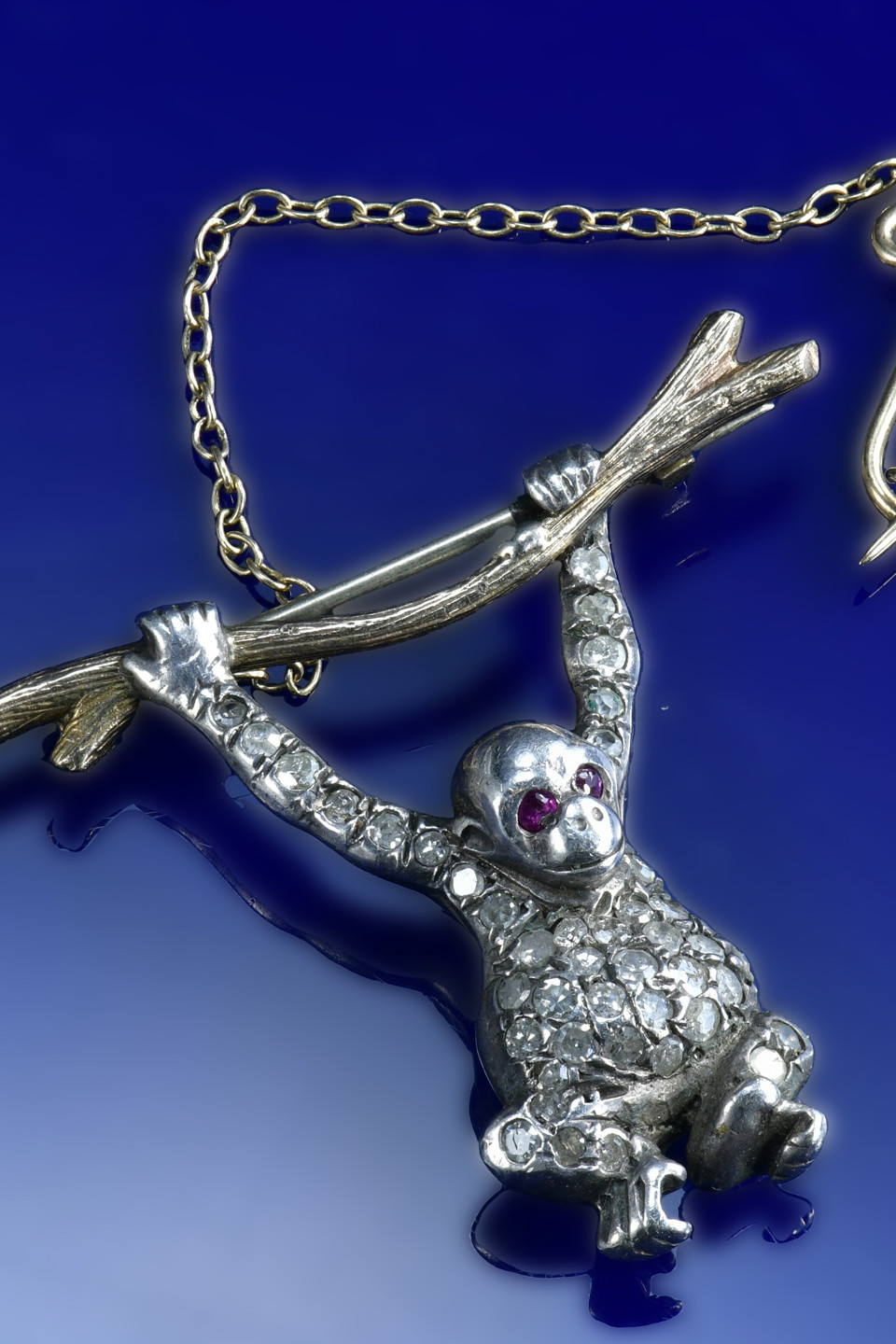 A 9ct gold and silver brooch set with diamonds and rubies in the form of a monkey