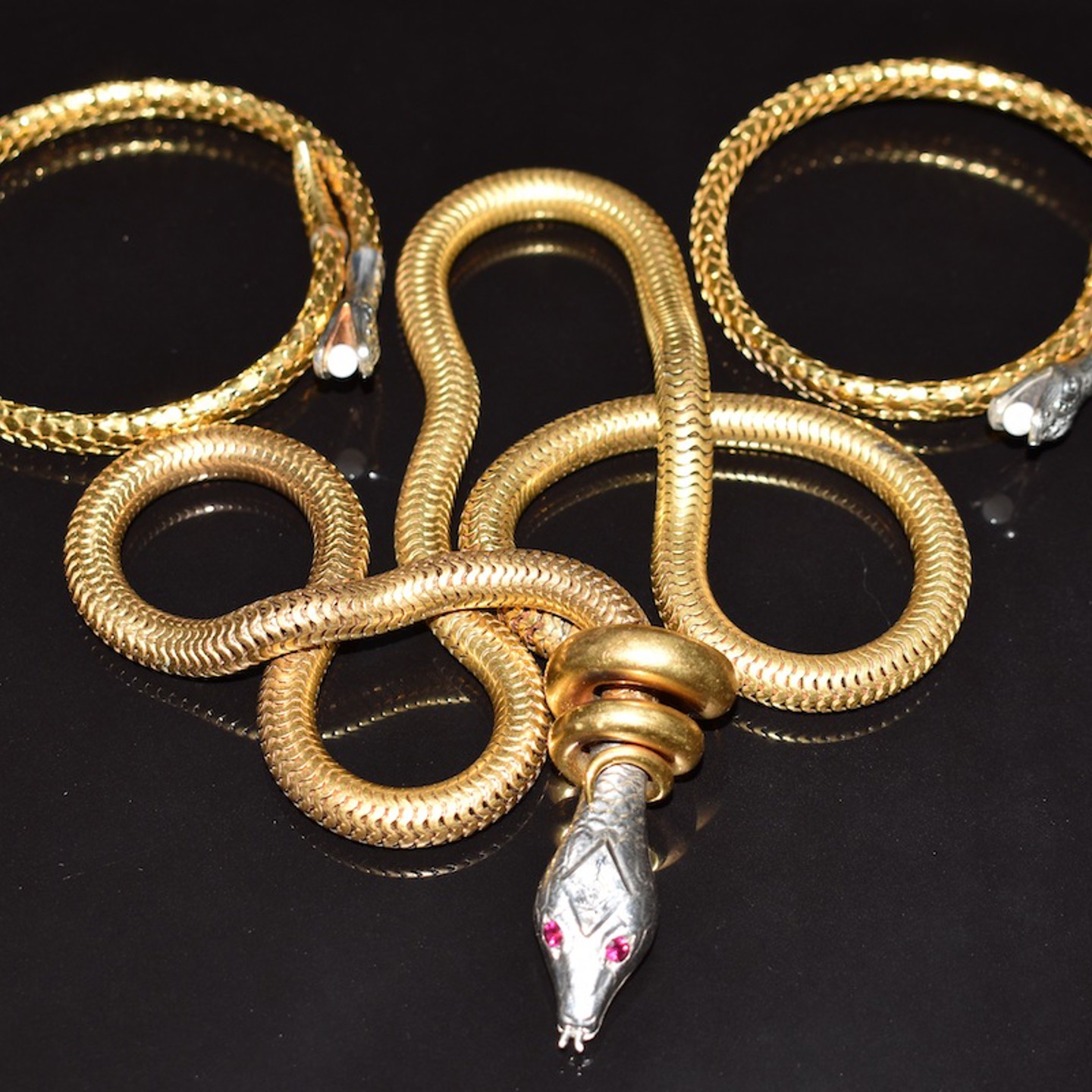 A Vintage Serpent Necklace With Synthetic Ruby Eyes And Two Rolled Gold Art Deco German Serpent Bangles. Sold For £420